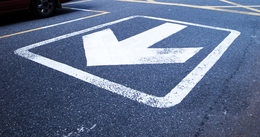Whit arrow road sign