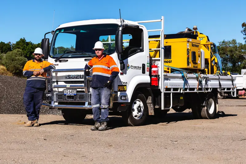 FRR-107-210-AMT-with-tray-body-Front-3-Quarter-Passenger-with-workers-Pro-Active-Drilling-Customer-story-1-min.jpg
